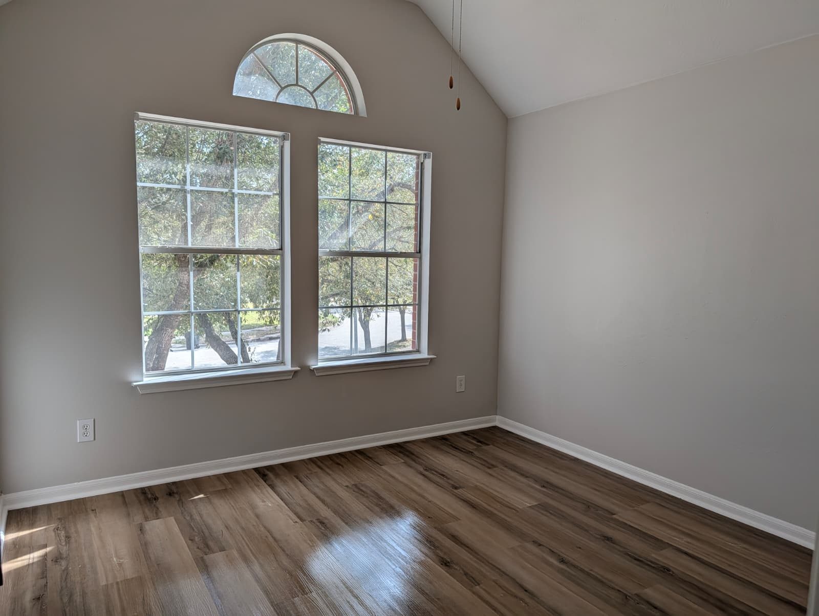 Same arched-window bedroom after the remodel