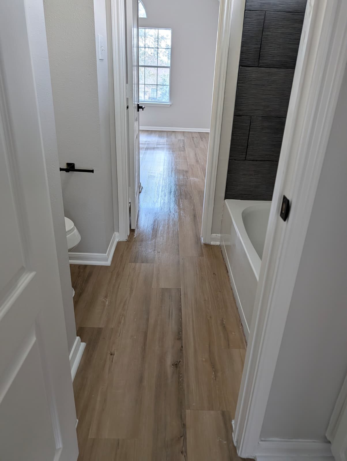 Hall looking into the remodeled bath and bedroom