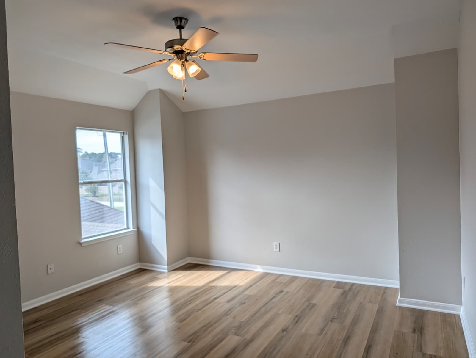 Bedroom with a ceiling fan and new wood-look floors