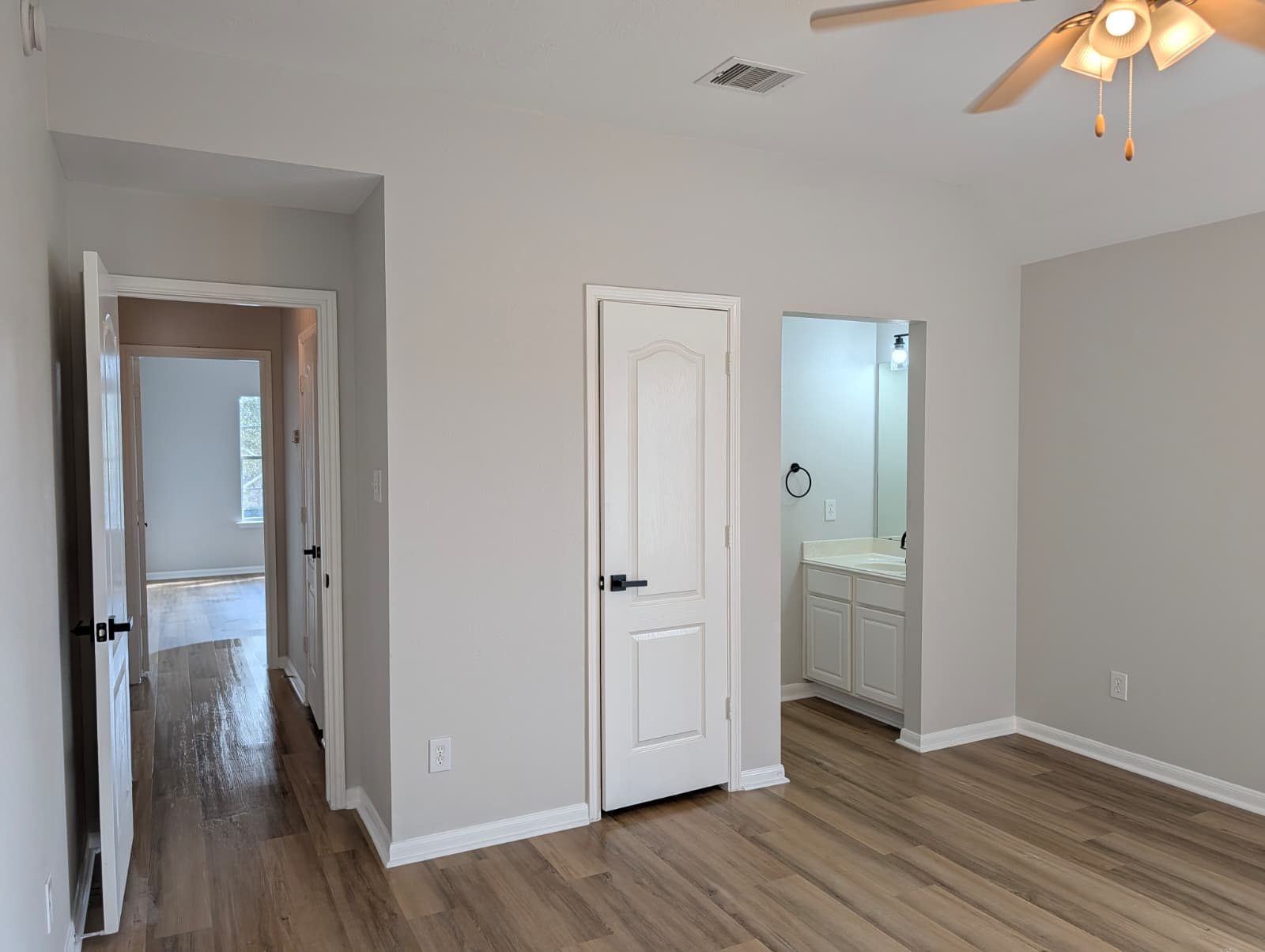 Bedroom with closet and bathroom doors after the remodel