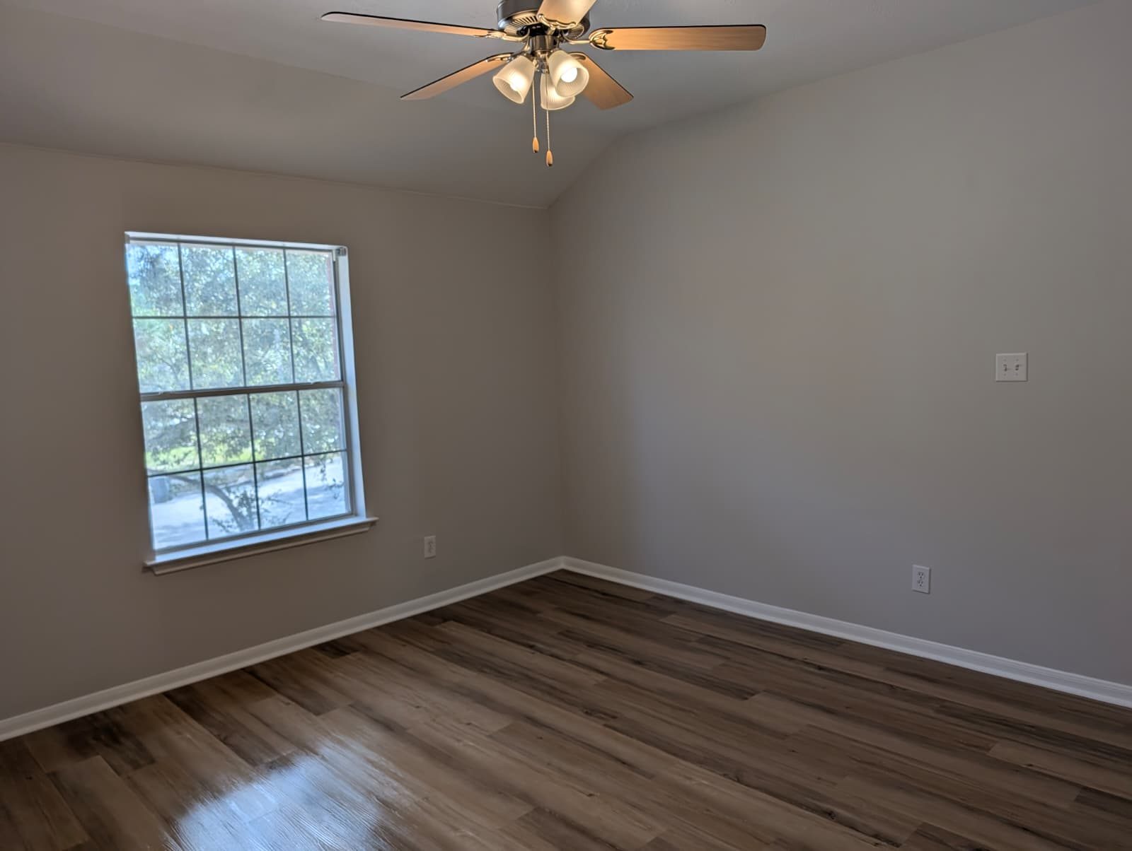 Bedroom with a ceiling fan after paint and flooring