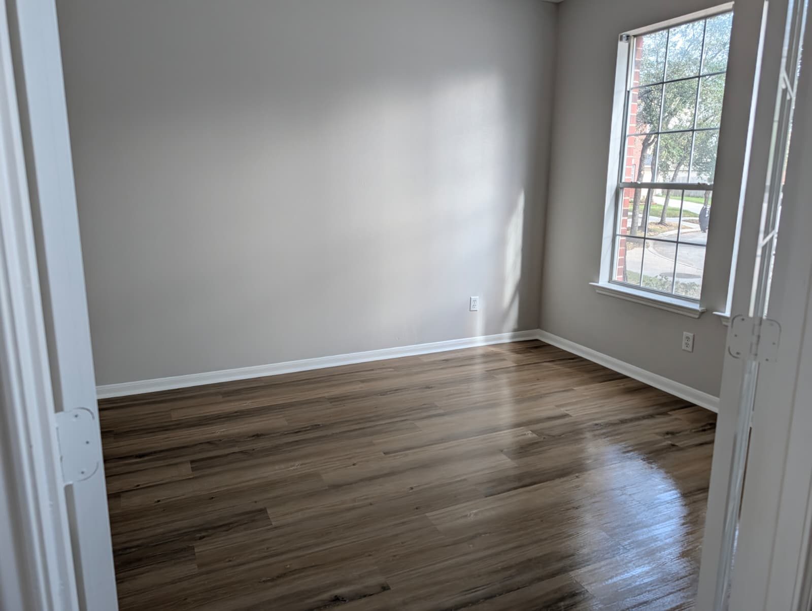 Bedroom corner with a window after new flooring