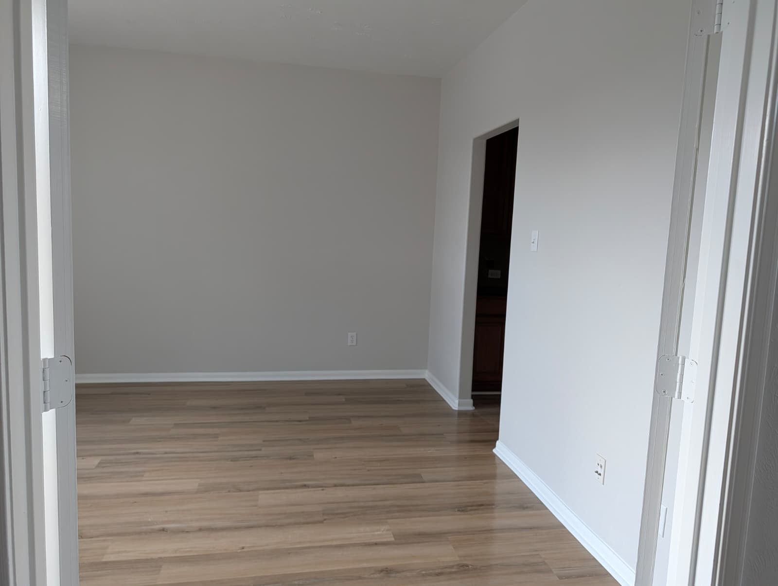 Doorway into a finished room with new flooring