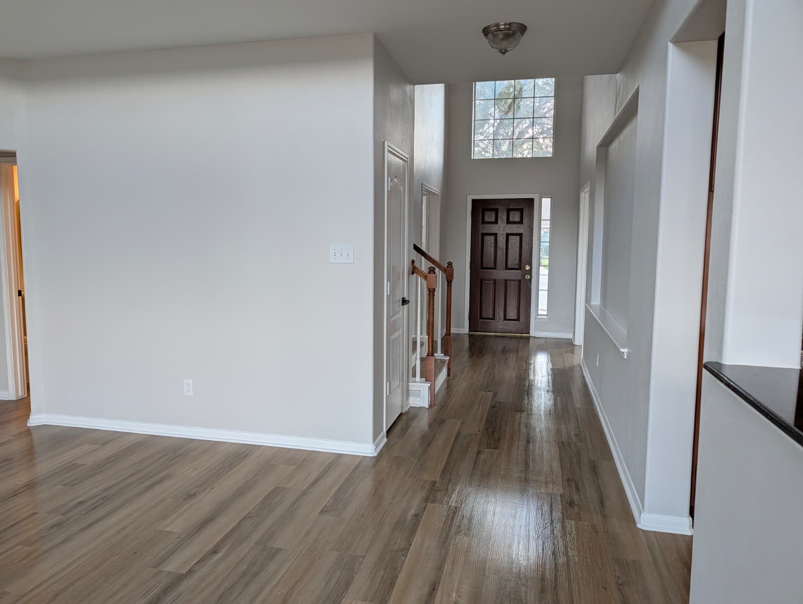 Entry after remodel with new floors and a dark front door