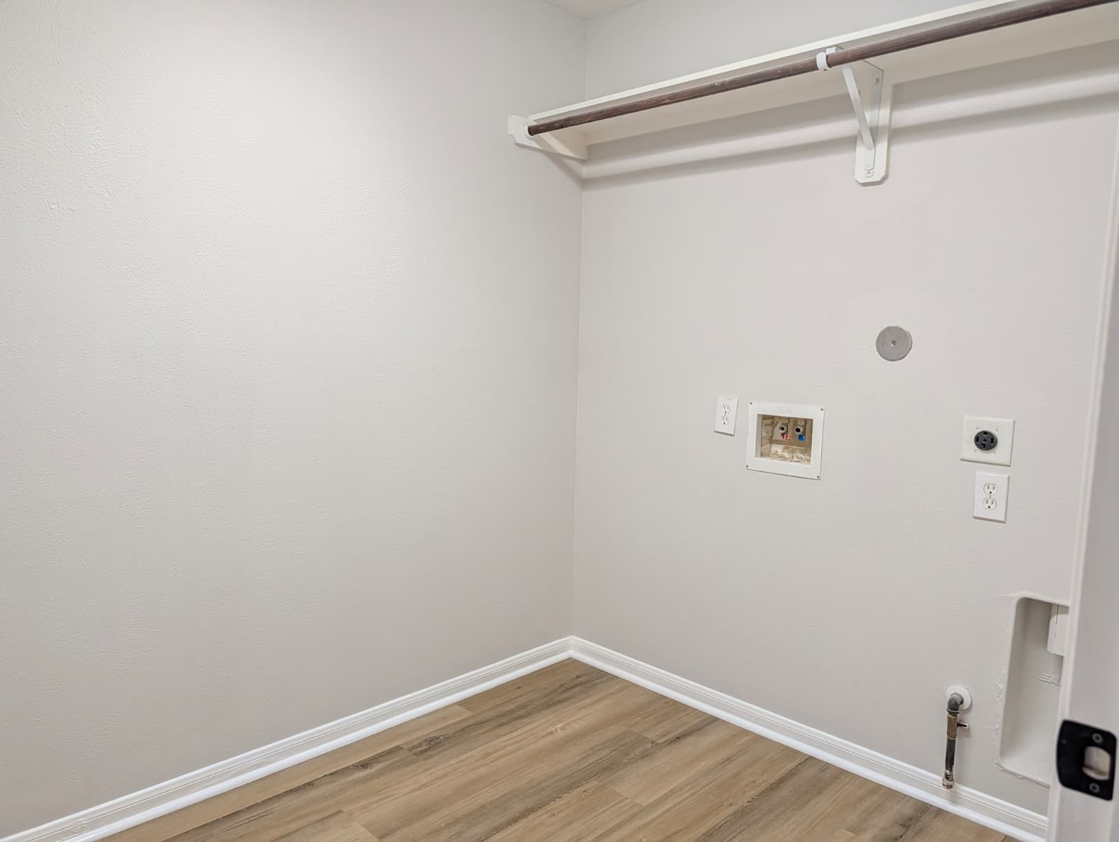 Laundry closet with a shelf and new flooring