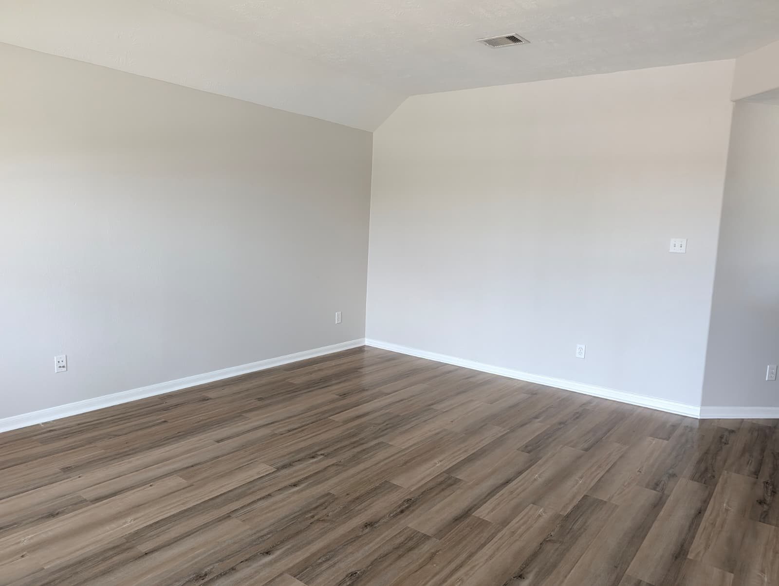 Finished room with new flooring and fresh paint
