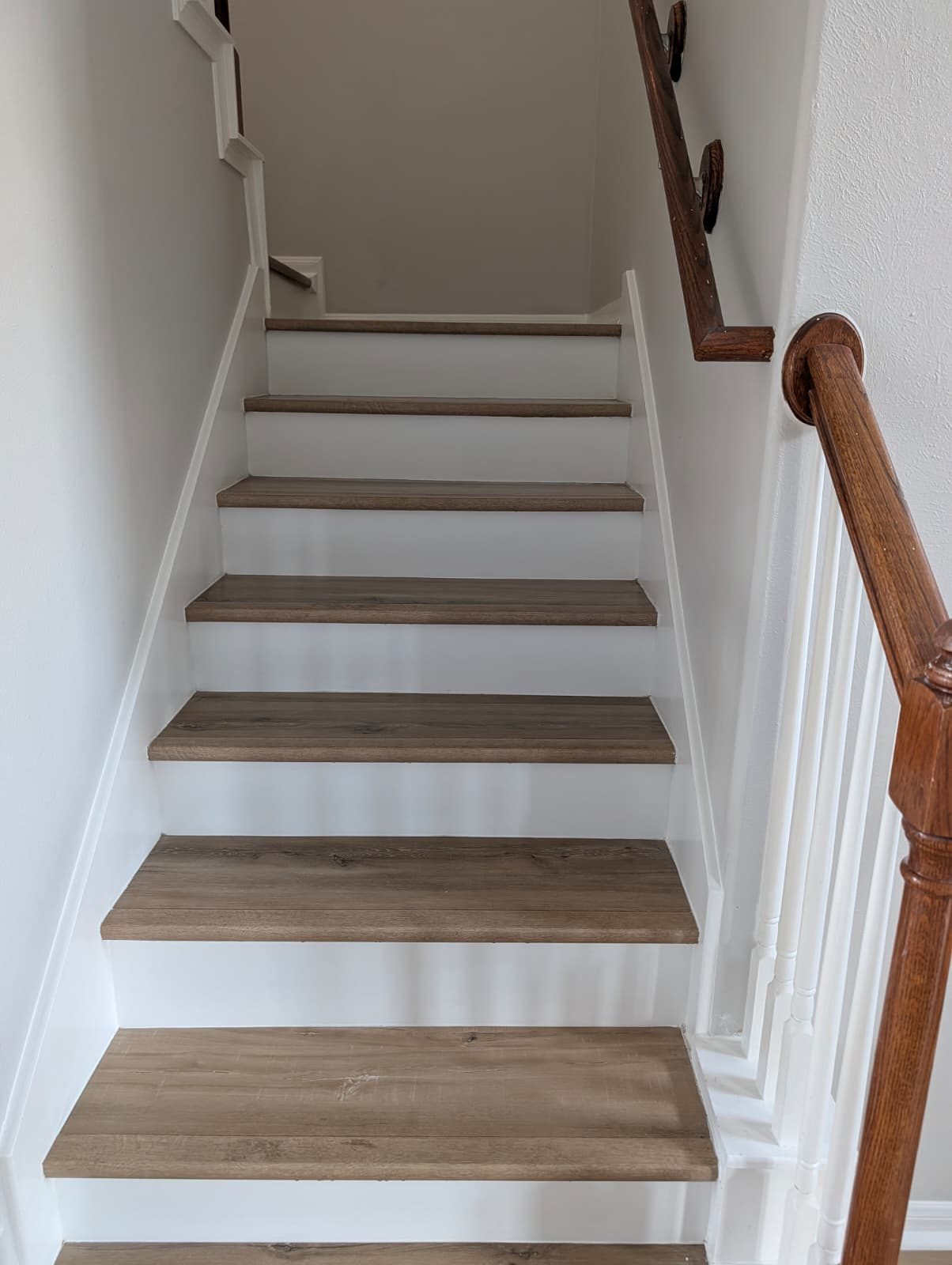 Stair treads and wood handrail after the remodel