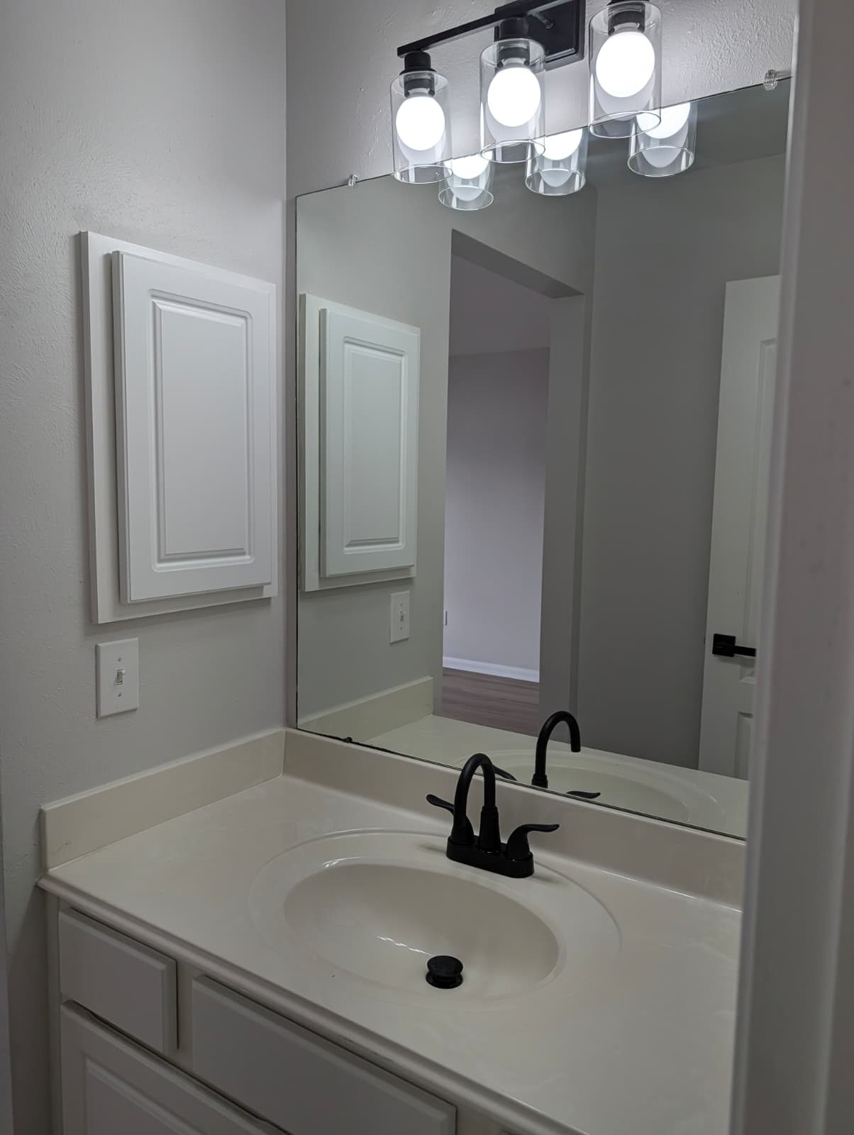 Bathroom vanity, mirror, and medicine cabinet after the remodel