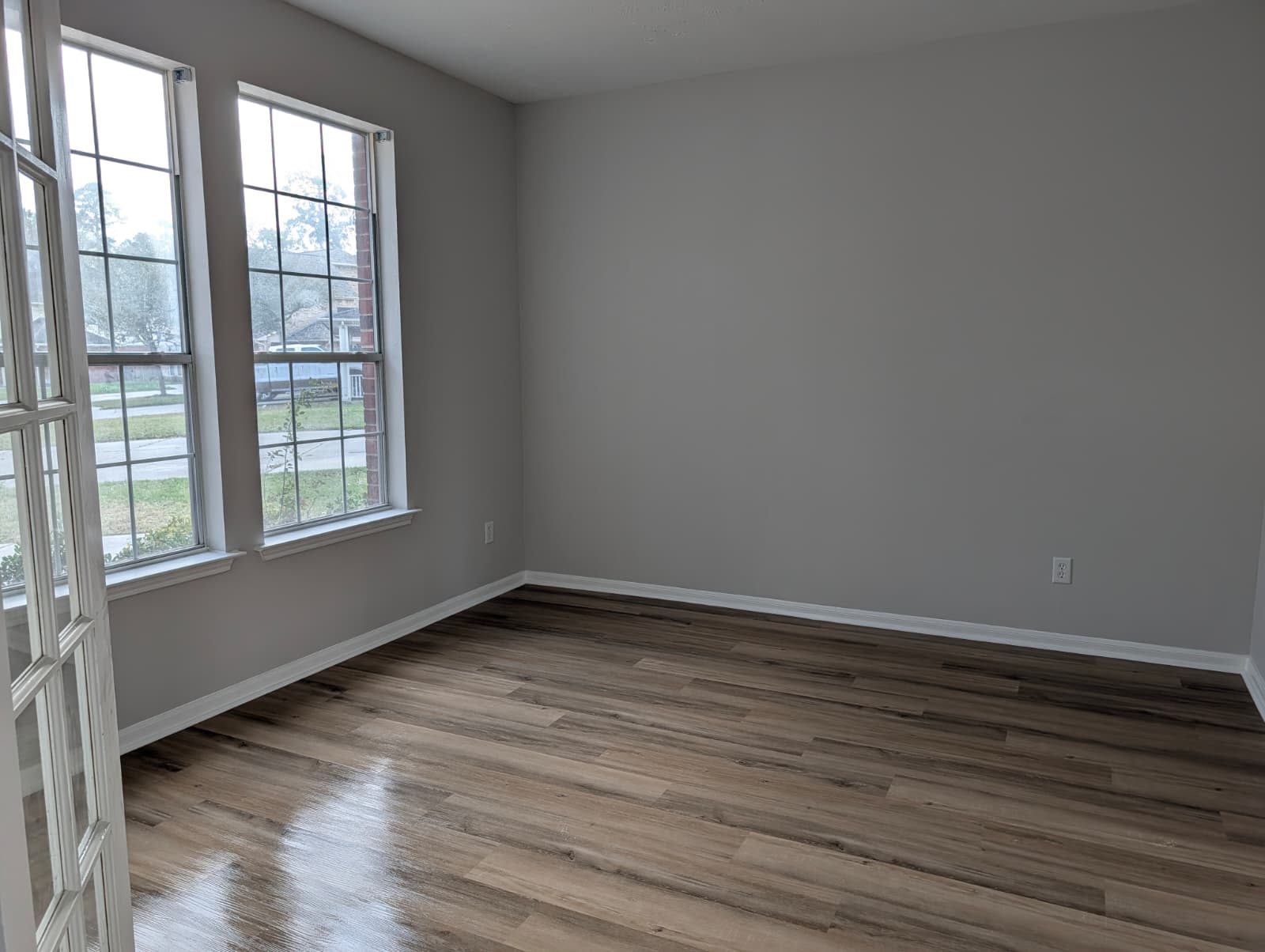 Room with new floors looking out front windows