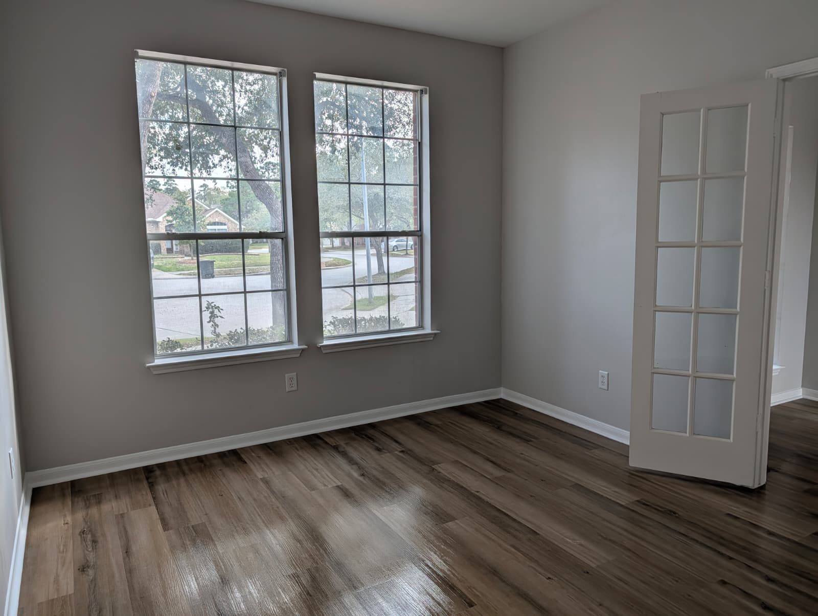 Painted room with new floors and a glass-pane door